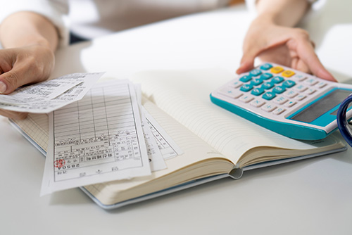  Invoices, a calculator and notebook on a work desk