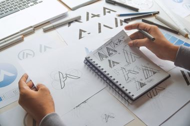  a photo of graphic designer drawing logo.