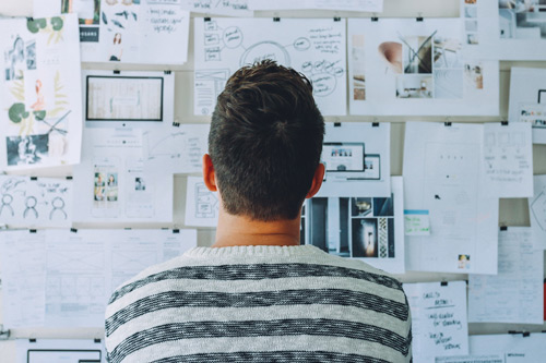 Entrepreneur brainstorming startup ideas on whiteboard