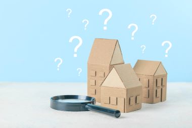 Questions on houses, a magnifying glass examining.