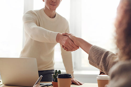 Reaching consensus at work place, shaking hands